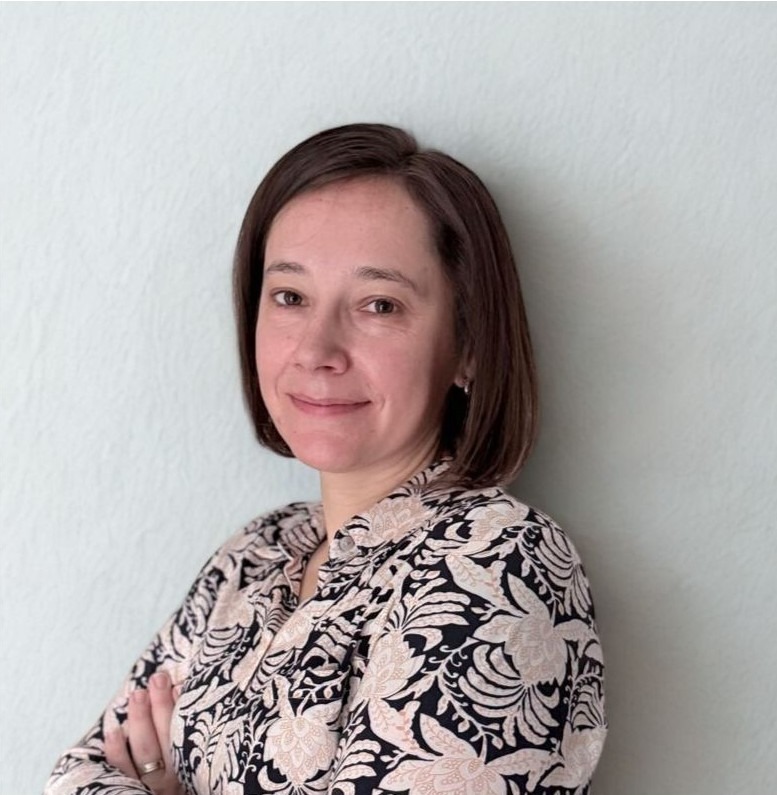 Maria Smith, smiling, wearing a floral patterned blouse